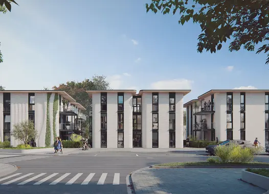 Moderne Wohnanlage mit drei weißen, mehrstöckigen Gebäuden, großen Fensterfronten und einigen vertikalen Begrünungen. Im Vordergrund ein Zebrastreifen, geparkte Autos und Gehwege, umgeben von Bäumen und Grünflächen. Blauer Himmel im Hintergrund.